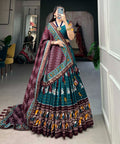 Teal Blue Adorn yourself in the artistry of Tussar silk and the mesmerizing allure of ikkat Patola prints with this exquisite lehenga choli for women - ReadyToWearshop
